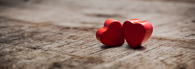 2 beautiful red hearts on a rustic wooden table on valentine's day
