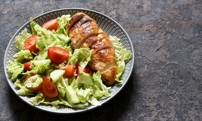 Baked chicken breast with honey and salad with cabbage and tomatoes. Healthy food, keto diet, paleo diet. Top view with copy space.