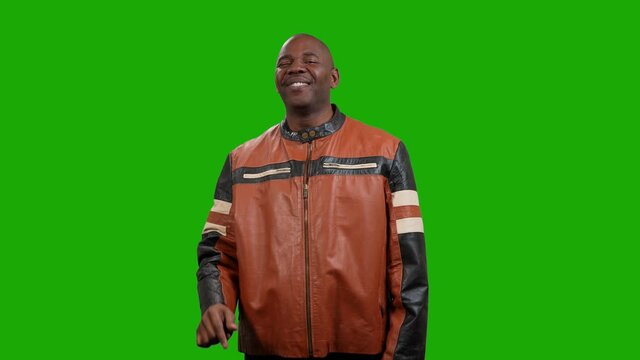 Handsome black man, waist up, double taps the screen with on finger and smiles on green screen background
