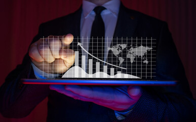 Businessman in suit showing rise and growth in infographic with tablet in hand. business analytics and financial technology concept.