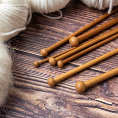 knitting needles on wooden table 