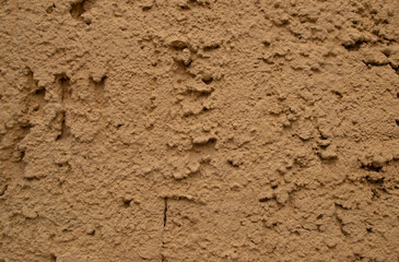 Old retro scrutched yellow brown plaster stucco wall background