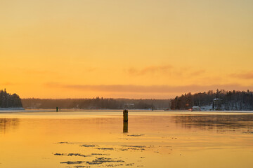 Freezing sea at sunset in the archipelago near Turku Finland.
