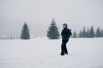Fototapeta na wymiar Hiker Walking in Mountains in Winter