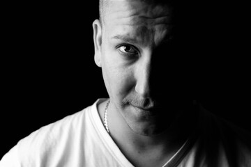 Close-up black and white portrait of a strong, confident male person.