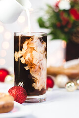 glass of coffee and christmas ornaments