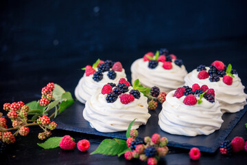 Homemade meringue basis for cake Pavlova with fresh blueberries and BlackBerry and powdered sugar...