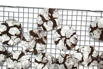 double chocolate crinkle cookies on wire rack with white background