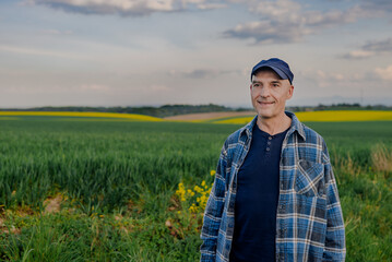Portrait of Successful Farmer Working at Farm Looking at Crops Wheat Field