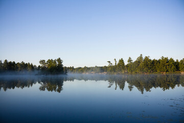 Calm lake water  with mist shot in Muskoka, Ontario Cottage Country