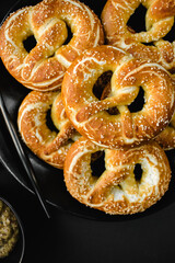 homemade pretzels with salt on black background