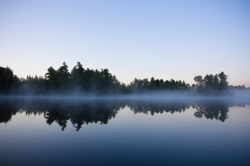 Calm lake water  with mist shot in Muskoka, Ontario Cottage Country