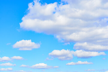 Naklejka na ściany i meble White cumulus clouds in blue sky at daytime. Natural background photo texture