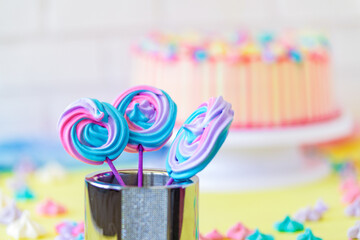 Lollipops Spiral Forms candy on pink background. Funny concept. Meringue candy on paper stick. Festive sweet table for children. Candy Bar. Cake as a background