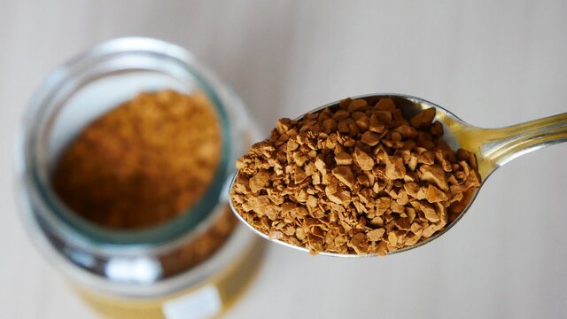 Close-up of a beautiful spoon filled with freeze-dried instant coffee