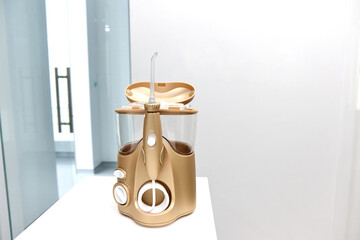 The dentist's golden sprinkler the irrigator stands on a table in the dentist's office inside are different nozzles