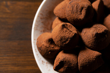 Chocolate truffles on a wooden background