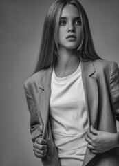 A beautiful young girl with blonde hair poses as a fashion model in different images and styles....