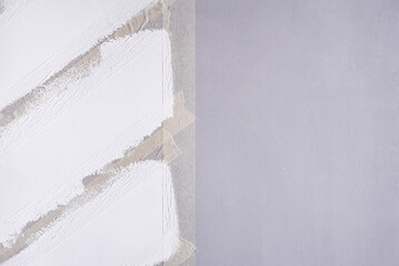 Painting a wall with masking tape. white zigzag strips on grey wall.