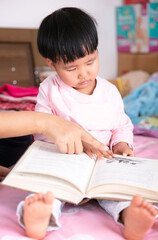 A little girl who reads carefully