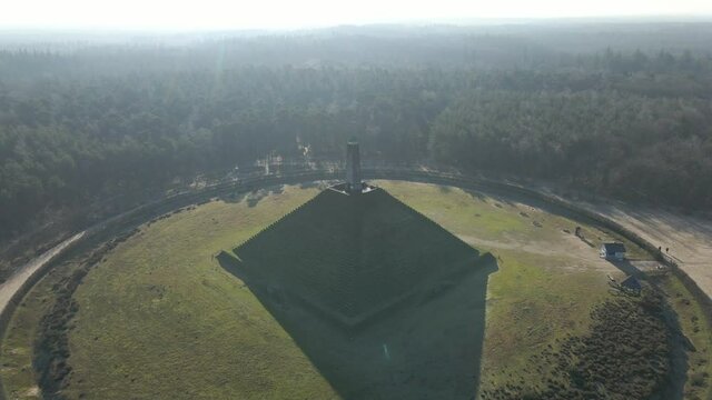 Aerial of Austerlitz Pyramid in the Netherlands on a sunny day - drone flying backwards. The Piramide van Austerlitz is a monument in the Netherlands, built in 1804 as a tribute to Napoleon Bonaparte.