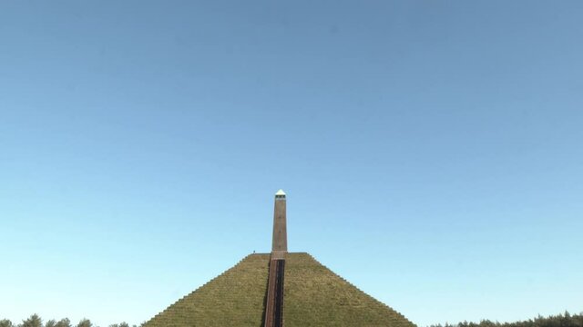 Tilting from bright blue sky to Austerlitz Pyramid monument in the Netherlands. The Piramide van Austerlitz is a monument in the Netherlands, built in 1804 as a tribute to Napoleon Bonaparte.