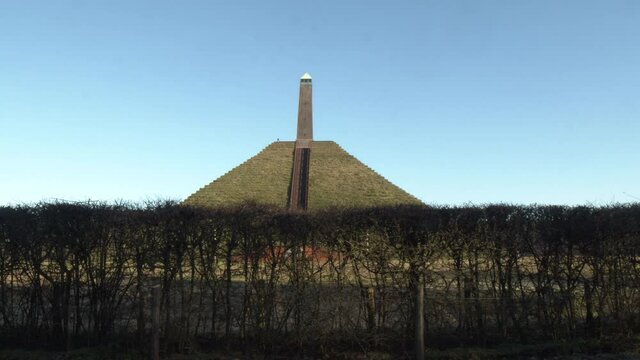 Tilt up to Austerlitz Pyramid monument agains a bright blue sky. The Piramide van Austerlitz is a monument in the Netherlands, built in 1804 as a tribute to Napoleon Bonaparte.