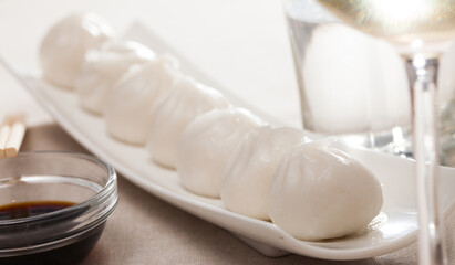 Fototapeta na wymiar Delicious chinese dumplings dim sum served on white plate