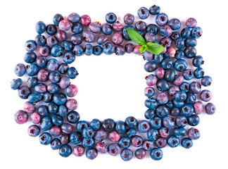 Fresh blueberries and leaves, berry frame isolated on white background, top view, frame