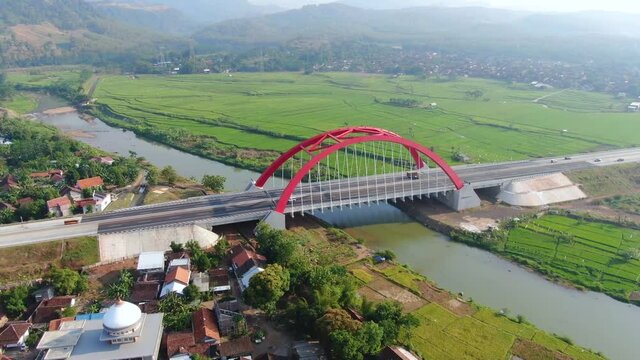Red Kali Kuto bridge on Trans Java toll road, Indonesia, aerial orbital view