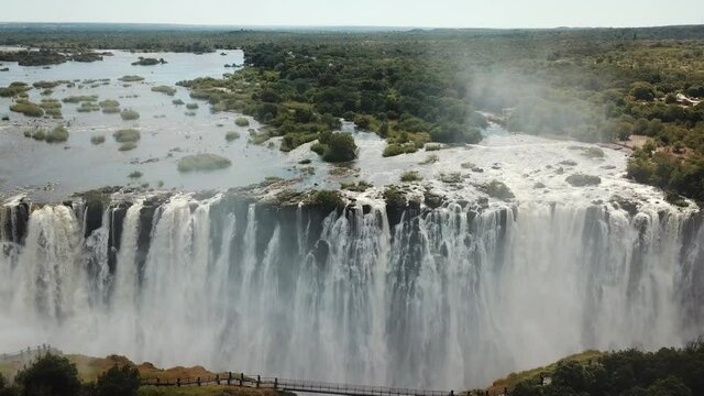 The Victoria Falls at the Border of Zimbabwe and Zambia in Africa. The Great Victoria Falls One of the Most Beautiful Wonders of the World. Aerial Shot From Above. Camera Moves Forward