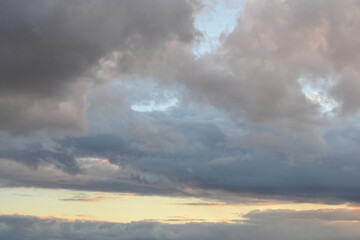 Dark gloomy gray cloudy sky before thunderstorm in summer. Storm heaven, gloomy backdrop.