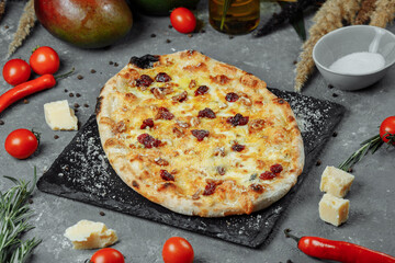 Hot four cheeses delicious rustic homemade american pizza with thick crust on black table