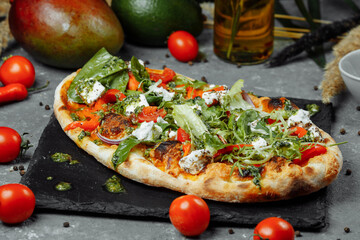 vegetarian pizza with cheese tomatoes and greens