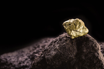 pure gold ore found in the mine, dark background.