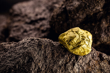 gold on rock, golden nugget on cave wall, gold mining