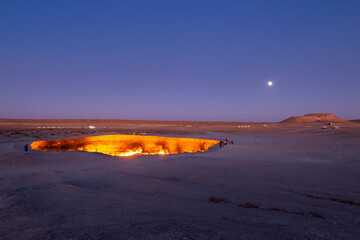 Darvaza Gas Crater in Derweze, Turkmenistan, part of Karakum Desert during twilight. Also know as...