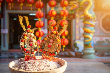 Red candles and burning incense sticks Paper gold with the Chinese alphabet Blessings written on it...