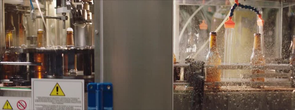 Fast motion video of a brewing process in a factory. Speed up video of beer bottles in a factory. Factory, brewery concept.