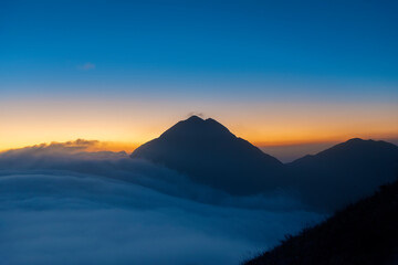 Naklejka na ściany i meble Mountain Fung Wong Shan - Lantau Peak at dusk. Natural landmark in hong kong