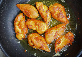 Close-up Thai fried chickens with tumeric on a pan