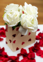 Gift of white roses with red petals around it
