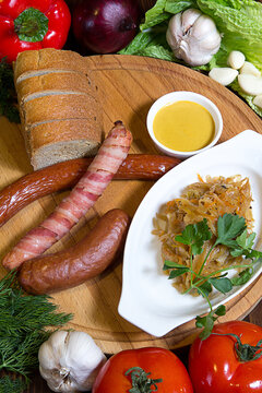 Traditional cabbage dish bigus with aromatic sausages. Restaurant service concept. Still life.