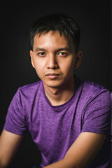Fototapeta premium a young man close up portrait, on black background