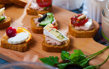 Apetizing canape with cheese, pate and vegetables