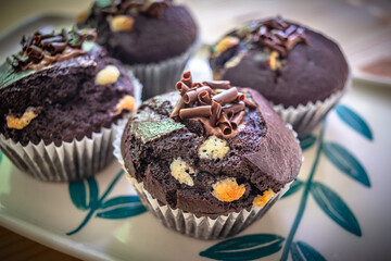 Chocolate muffins with crispy top.