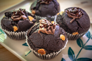 Chocolate muffins with crispy top.