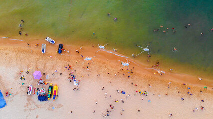 Aerial view of Sunset in Phu Quoc beach with nice view. Tourists, sunbeds and umbrellas on beautiful day in Sanato beach, Phu Quoc island, Vietnam