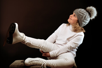 Figure skater girl in skates. White clothes. Blonde 9 years old.