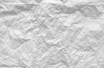 Top view of crumpled white paper for the background. Light and soft color background, large crumpled paper background texture for art design. The surface is not smooth but attractive.